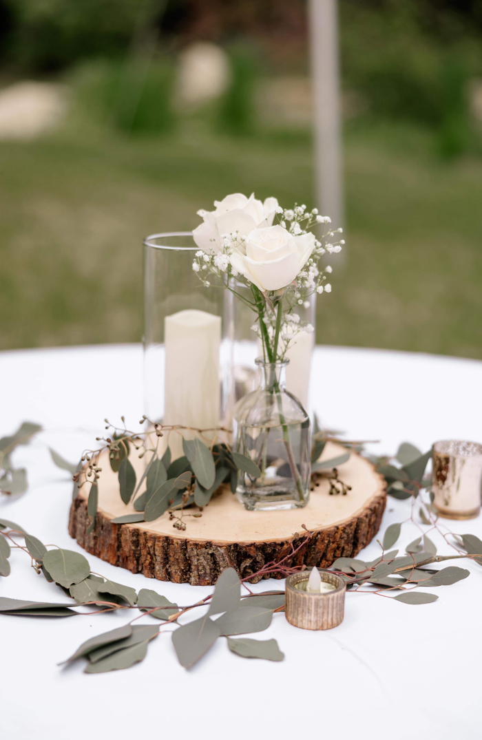 Wildflower nature wedding centerpieces with wood slices, bottles